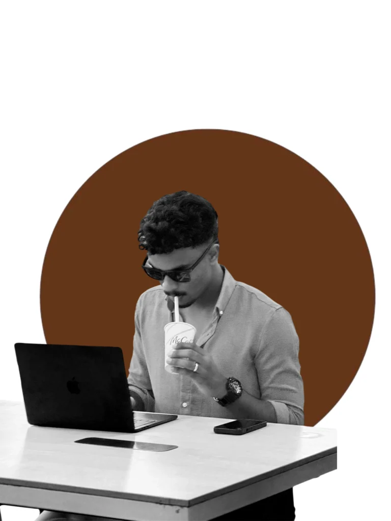 A freelance perfomance marketer in sunglass doing work in laptop